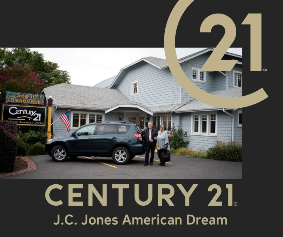 Kathy and John Aitchison standing in front of Century 21 JC Jones in Grants Pass Oreogn